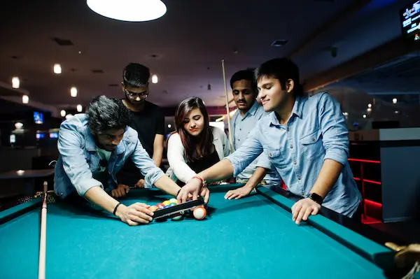 Adults enjoying premium bowling lanes and cocktails